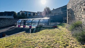 A greenhouse structure with a transparent roof, surrounded by stone walls and a grassy area. - Stunning home in Coutances with private swimming pool, can be inside or outside (Coutances)