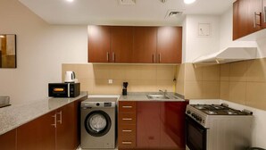 Fridge, microwave, oven, stovetop - Convenient Location in JVC Bright 1BR with Balcony (Dubai)