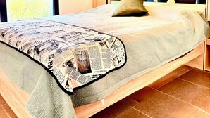 A bedroom with a bed, wooden headboard, and a window with a view. - View of the Esterel massif from the Avant-Scene, Frejus on foot (Fréjus)