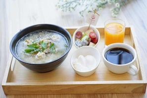A tray with a bowl of soup, a cup of coffee, a glass of orange juice, a bowl of yogurt, and a small bowl of fruit. - Kyoto Great Hotel (Chiang Mai)