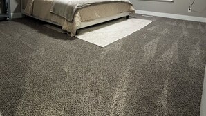 A bedroom with a bed, a window with blinds, a flat-screen TV mounted on the wall, and a ceiling light. - Newly remodeled home on a quiet street with a large yard. (Salt Lake City)
