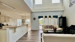 A spacious living area with a kitchen, a sofa, and a coffee table. - 1018 Wonderful House/ swimming pool and billiards (393266) (Davenport)