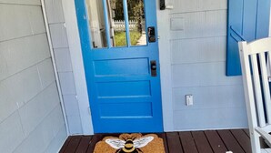 A blue door with a glass panel, a white chair, and a doormat with a bee design. - 227 Country House of vacation /Eustis (Eustis)