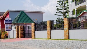 A modern building with a green roof, a gated entrance, and a sign for 'DE GRACEMANEL TERRACE'. - De GraceManuel Terrace (Gbawe)