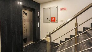 Un ascenseur d’hôtel doté d’un écran numérique affichant les numéros des chambres, de 101 à 409.