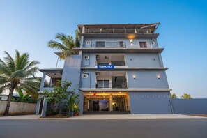A modern multi-story hotel with a prominent 'fabHOTELS' sign, a balcony on the second floor, and a star-shaped light fixture above the entrance. - Fabhotel Ravai Beach - 500m From Calangute Beach (Calangute)