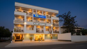 A multi-story hotel with a sign for 'Fab Hotels' and 'Amrit Residency'. - FabHotel Amrit luxury Inn by Amrit Residency (Gurugram)