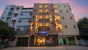 A multi-story hotel with a ground-level AC Deluxe Room and a sign for 'FadHotels'. - Fabhotel Rose Residency (New Delhi)