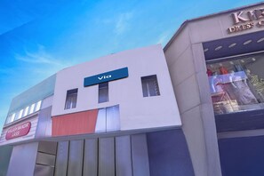 A building with a 'Via' sign, a 'Kailash Mandir Lassi' sign, and a store with mannequins. - Via Woodlands (Mumbai)