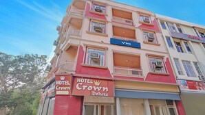 A multi-story hotel with balconies, a 'Hotel Crown Deluxe' sign, and a 'Via' sign above the entrance. - Via Crown DX (New Delhi)