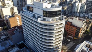 A high-rise building with multiple balconies, a rooftop terrace, and a corner location in an urban setting. - BAH Independencia By iPPA (Buenos Aires)