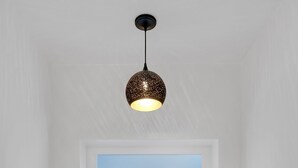 A modern bathroom with a white bathtub, a ceiling light fixture, and a window with a view. - Casa de Kiva - your Cochise County Escape (Cochise)
