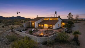A two-story house with a patio area, a fire pit, and a water tank. - Casa de Kiva - your Cochise County Escape (Cochise)