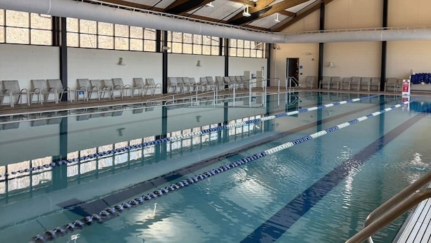 An indoor swimming pool with clear lanes, wooden beams, and a tiled floor. - Spacious House with King beds, Fire places, Game Room and Dog friendly. (Galena)