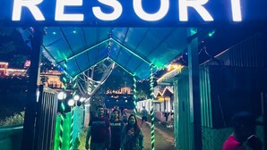A sign for Sukhdev Resort with a covered walkway and decorative lighting. - Sukhdev Resort Rishikesh (Rishikesh)