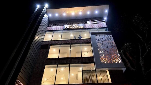 A multi-story hotel with a prominent sign reading "Hotel Sparrow." - Hotel Sparrow (Dehradun)
