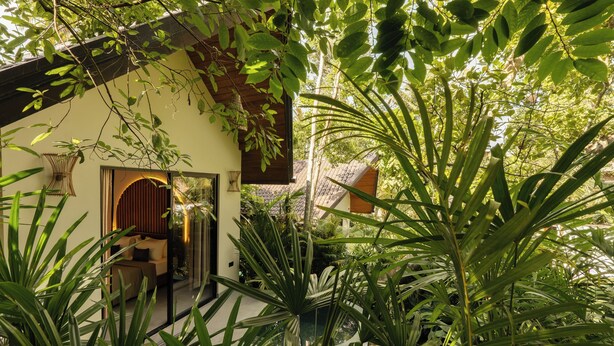 A traditional-style building with a wooden exterior, surrounded by lush greenery and a well-maintained garden. - The Benison (Ahangama)