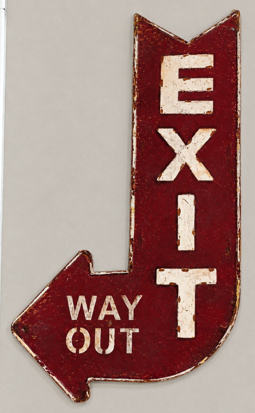 Señal direccional con el texto 'EXIT' y 'WAY OUT', que indica una ruta de salida.