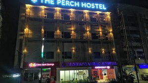 The Perch Hostel building with a neon sign, adjacent to a China Bank Savings branch and Olongapo Animal Hospital. - The Perch Hostel (Olongapo)