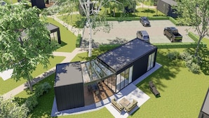 A modern house with a large glass patio, a swimming pool, and a well-maintained lawn. - Spacious Home by Palette Resort De-steppe (Ulicoten)