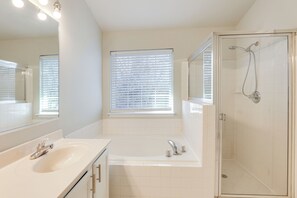 A bathroom with a sink, mirror, bathtub, and shower. - 5 Mi to Show Place Arena: Quiet Townhome w/ Patio (Upper Marlboro)