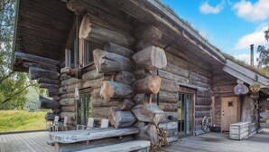A log cabin with a wooden deck, a bench, and a door. - 3 bedroom accommodation in Beauly, near Drumnadrochit (Beauly, near Drumnadrochit)