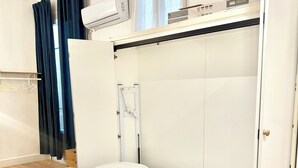 A modern hotel room with a bed, white linens, a built-in wardrobe, and a window with curtains. - Studio Carré d'Or with balcony (Nice)