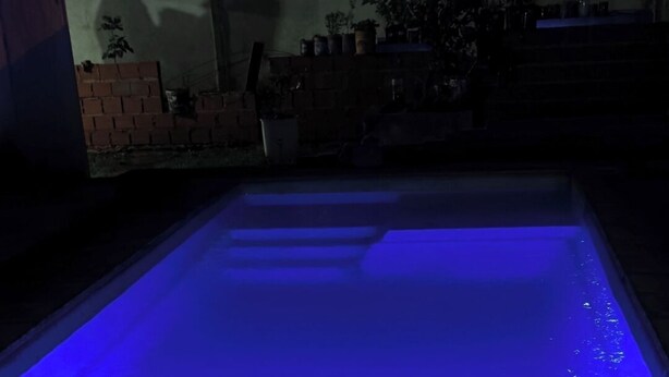 A swimming pool with a blue light.