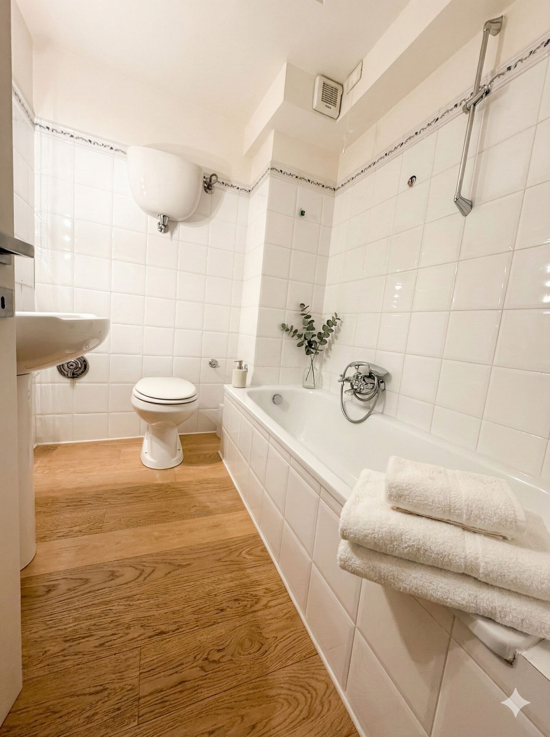 A bathroom with a toilet, sink, and bathtub.
