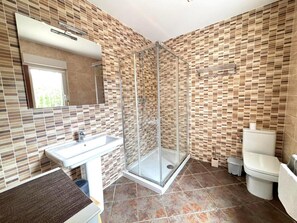 A bathroom with a glass-enclosed shower, a sink, and a toilet. - Charming Private House with Garden, 300m from Canyelles Beach - Sleeps 6, Roses, Spain (Roses)
