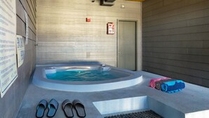 A spa area with a hot tub, towels, and slippers. - Moose Mgmt at Moose Lodge 9: King Beds, Hot Tub, Walk to Skiing (Park City)