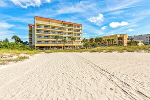 A beachfront hotel with multiple balconies and a sandy beach in the foreground. - Price Drop! Madeira Norte 416🌞Beachfront Condo🐬Private Balcony (Madeira Beach)