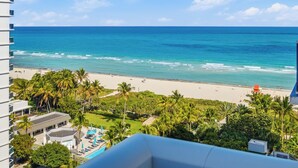 A hotel with a pool, a beach view, and palm trees. - Oceanview Private Condo at 1 Hotel & Homes - 1207 (Miami Beach)