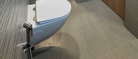 A bathroom with a sink, mirror, and toilet.