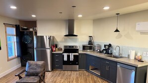 A modern kitchen with stainless steel appliances, a built-in oven, and a dishwasher. - Comfort and warmth, convenience to Campus at Pike Bay Apartment (Chassell)