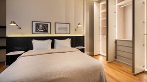 A neatly arranged bedroom with a bed, bedside tables, and a wardrobe. - The Muradiye Luxury Apartments (Istanbul)