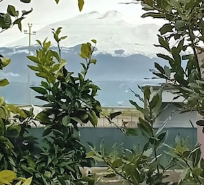 A view of a mountainous landscape with a building in the background.