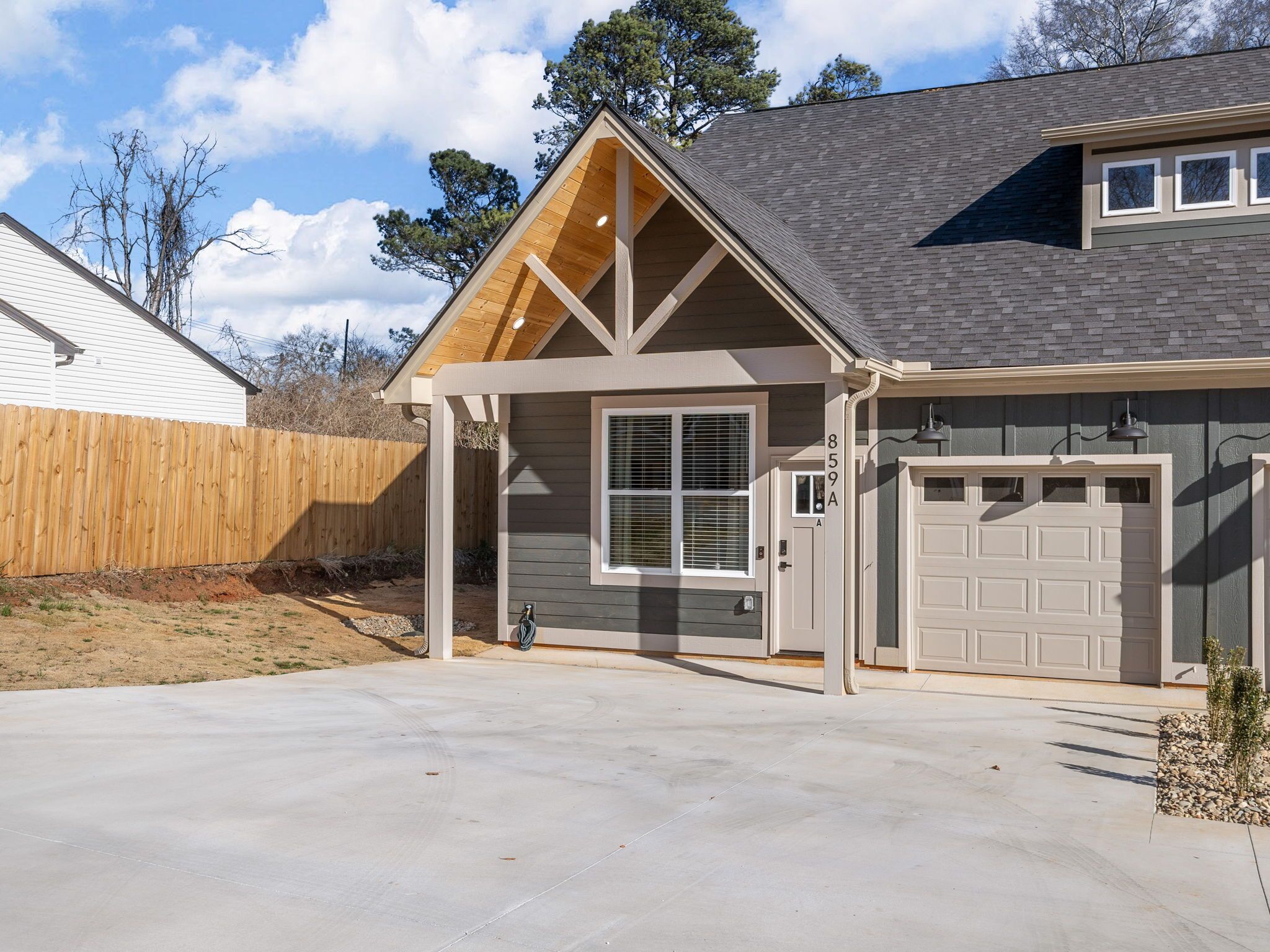A single-story house with a garage, a covered porch, and a sloped roof.