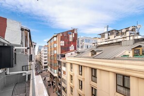 A multi-story building with a mix of architectural styles, including a red brick building and a beige building with large windows. - Modern Penthouse w/ Private Terrace Near Metro (istanbul)