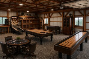 A billiards room with a pool table, foosball table, shuffleboard table, and a Skee-Ball machine. - Mountaintop RV Camping with Alpacas @ Deep Creek (Oakland)