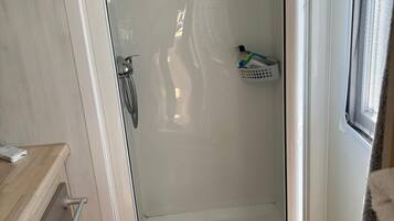 Shower, towels, soap, toilet paper