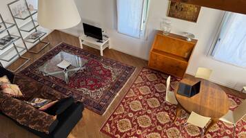 Deluxe Apartment | Living area | 40-inch LCD TV with cable channels