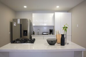 Fridge, stovetop, coffee/tea maker, cookware/dishes/utensils