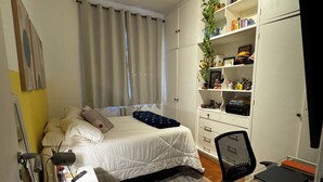 A bedroom with a bed, bedside table, desk, chair, and a wardrobe. - Leblon Penthouse: Everything within walking distance! (Rio de Janeiro)