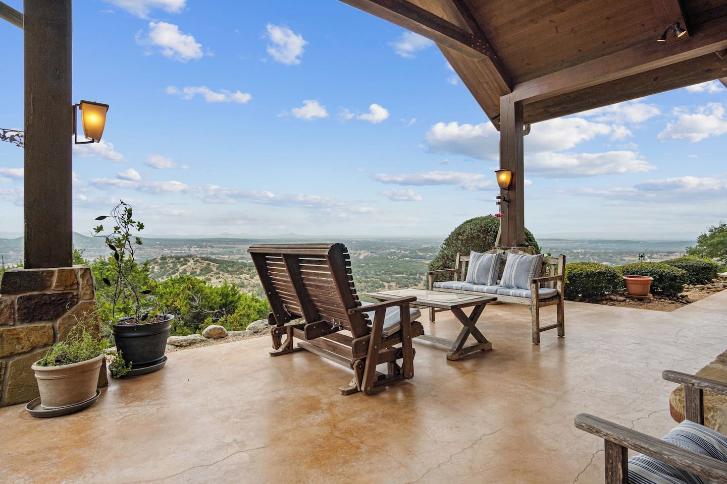 A covered outdoor seating area with a view of the landscape.