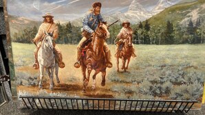 A painting of three individuals on horseback in a natural landscape with mountains in the background.