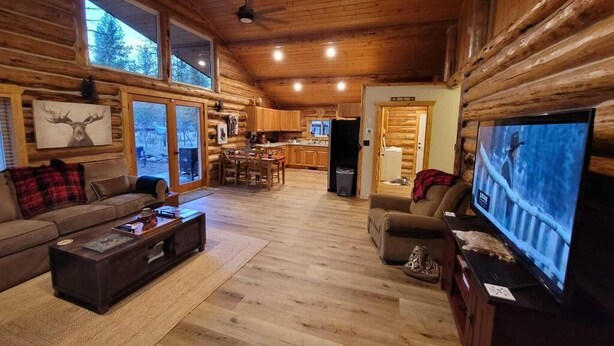 A log cabin interior with a living room, kitchen, and dining area. - Tranquil 3 Bedrm house w AC in Seeley Lake, MT-Dogs Allowed-Fenced Yard-Firepit (Seeley Lake)