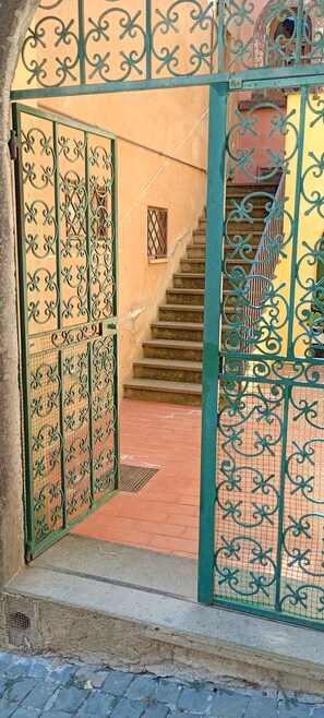 A gated entrance with a staircase leading to a building.