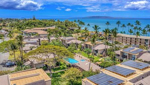 A resort with multiple buildings, a swimming pool, and solar panels. - Kihei Garden Estates Condo | Pool, Hot Tub, Ground Floor, AC, Walk to Beach (Kihei)