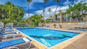 A swimming pool with lounge chairs, palm trees, and a building with a sign indicating no diving. - Kihei Garden Estates Condo | Pool, Hot Tub, Ground Floor, AC, Walk to Beach (Kihei)